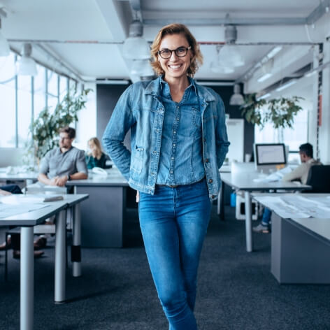 A happy employer posing in her office